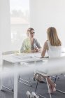 Barefoot female architect meeting with colleague in conference room — Stock Photo