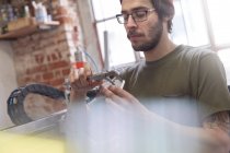 Male designer using calipers in workshop — Stock Photo