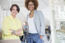 Portrait of female colleagues smiling in office — Stock Photo