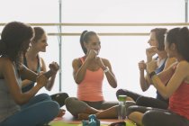 Women gesturing with fists in exercise class gym studio — Stock Photo