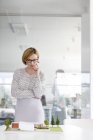 Female architect examining model in conference room — Stock Photo
