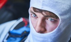 Close up serious race car driver wearing protective mask — Stock Photo