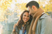 Portrait smiling, affectionate couple on autumn street — Stock Photo