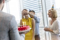 Empresários comemorando aniversário com bolo no escritório — Fotografia de Stock