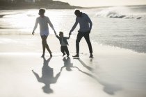 Happy family having fun on beach — Stock Photo