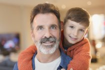 Close up portrait smiling father and son hugging — Stock Photo