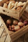 Still life fresh, organic, healthy root vegetables in wooden crates — Stock Photo