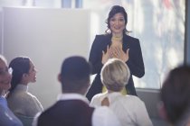 Businesswoman gesturing, leading conference meeting — Stock Photo