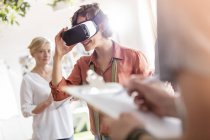 Woman using virtual reality simulator glasses in office — Stock Photo