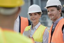 Smiling engineers meeting at construction site — Stock Photo