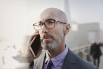 Close up serious businessman talking on cell phone — Stock Photo