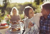 Affectionate father and daughter enjoying sunny garden party — Stock Photo
