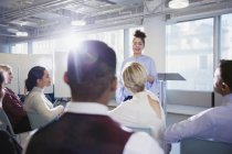 Businesswoman leading conference presentation, answering audience questions — Stock Photo