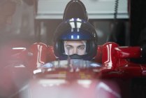 Focused formula one race car driver wearing helmet — Stock Photo