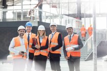 Portrait confident engineers and architects at construction site — Stock Photo