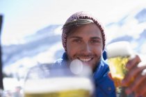 Portrait of man drinking beer outdoors — Stock Photo
