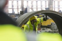 Aço trabalhador examinando tubo na fábrica — Fotografia de Stock