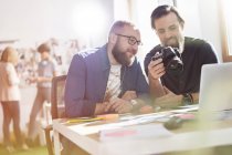 Photographer design professionals with SLR camera in office — Stock Photo