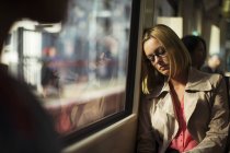 Businesswoman napping on train — Stock Photo