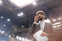 Manager with walkie-talkie in steel factory — Stock Photo