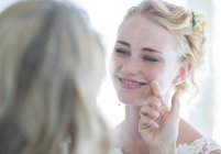 Matron of honor and bride facing each other and smiling — Stock Photo