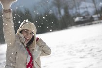 Portrait of exuberant woman in snow — Stock Photo