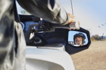 View of senior man in side-view mirror riding motorcycle — Stock Photo