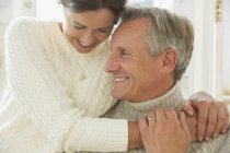 Close up affectionate mature couple hugging and smiling — Stock Photo