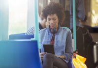 Woman using digital tablet on train — Stock Photo