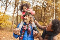 Playful young family in autumn park — Stock Photo