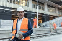 Portrait confident engineer with digital tablet at construction site — Stock Photo