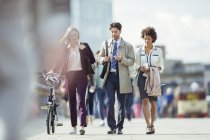 Pessoas de negócios andando e conversando na cidade — Fotografia de Stock
