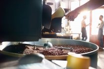 Coffee roaster roasting coffee beans — Stock Photo