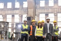 Portrait confident manager and steel worker team in factory — Stock Photo