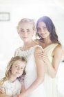 Portrait of bride and bridesmaids looking at camera — Stock Photo