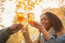 Friends toasting beer glasses outdoors — Stock Photo