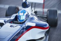 Формула 1 гоночний водій автомобіля в шоломі на спортивній трасі — стокове фото