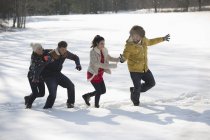 Amici che giocano nella neve durante il giorno — Foto stock