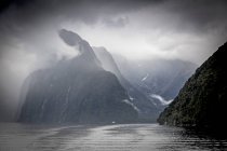 Clouds and fog surrounding cliffs, Milford Sound, South Island New Zealand — Stock Photo