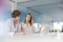 Female architects talking at laptop in conference room meeting — Stock Photo