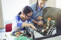 Girl students assembling computer in classroom — Stock Photo