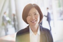 Portrait smiling businesswoman at modern office — Stock Photo