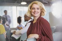 Portrait confident, smiling businesswoman in conference audience — Stock Photo