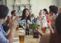 Friends clapping for happy woman celebrating birthday at restaurant table — Stock Photo