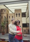 Portrait smiling pregnant multi-ethnic couple at moving van — Stock Photo