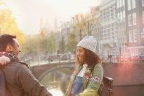 Young couple on urban autumn bridge over canal, Amsterdam — Stock Photo