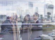 Business people talking at urban window with city view, London, UK — Stock Photo