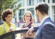 Business people talking near car — Stock Photo