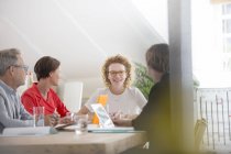 Four people at meeting in modern office — Stock Photo