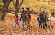 Multi-generation family walking in autumn park — Stock Photo